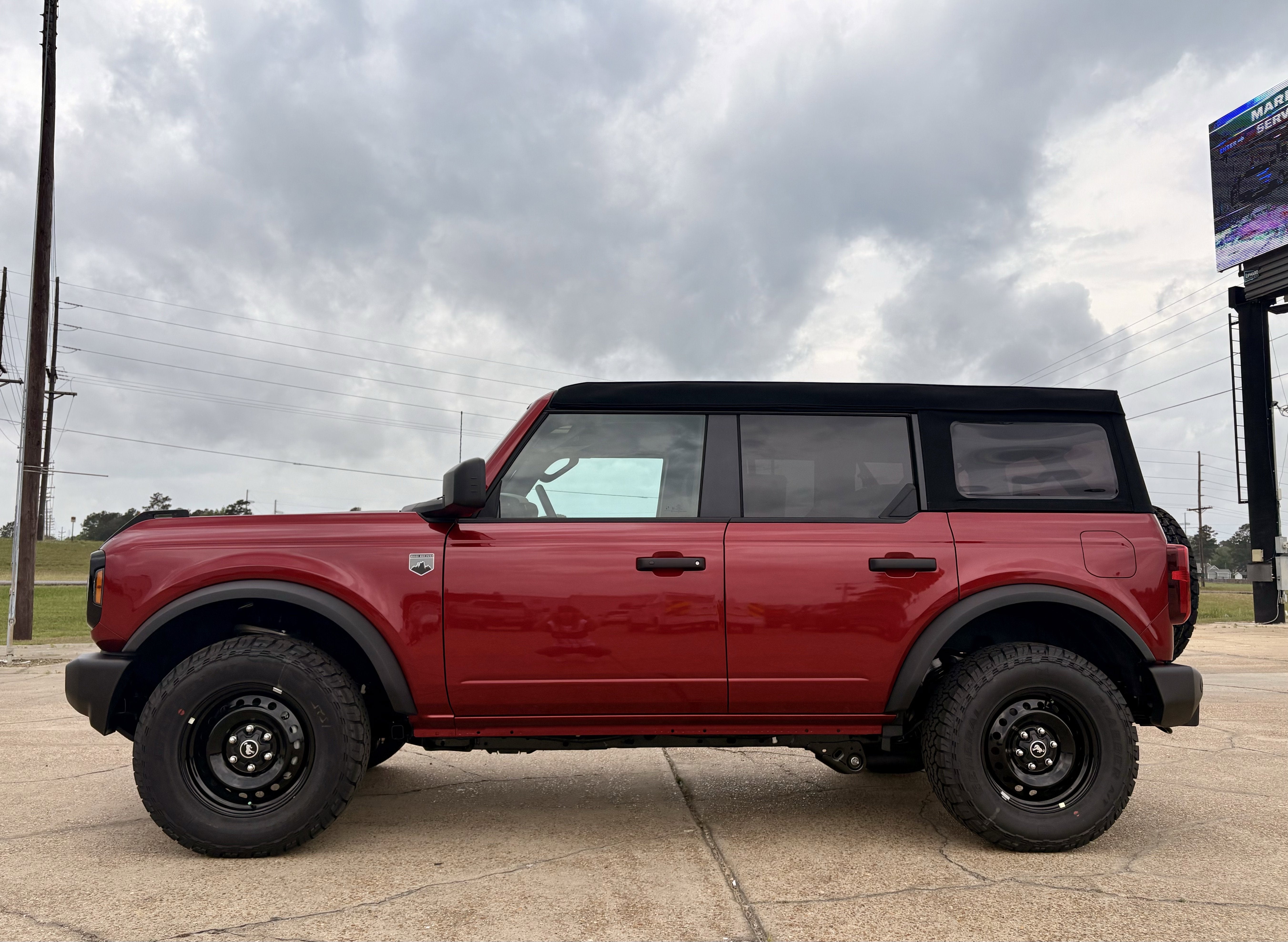 2026 Ford Bronco Big Bend in Ruby Red Metallic Tinted Clearcoat — front three-quarter view
