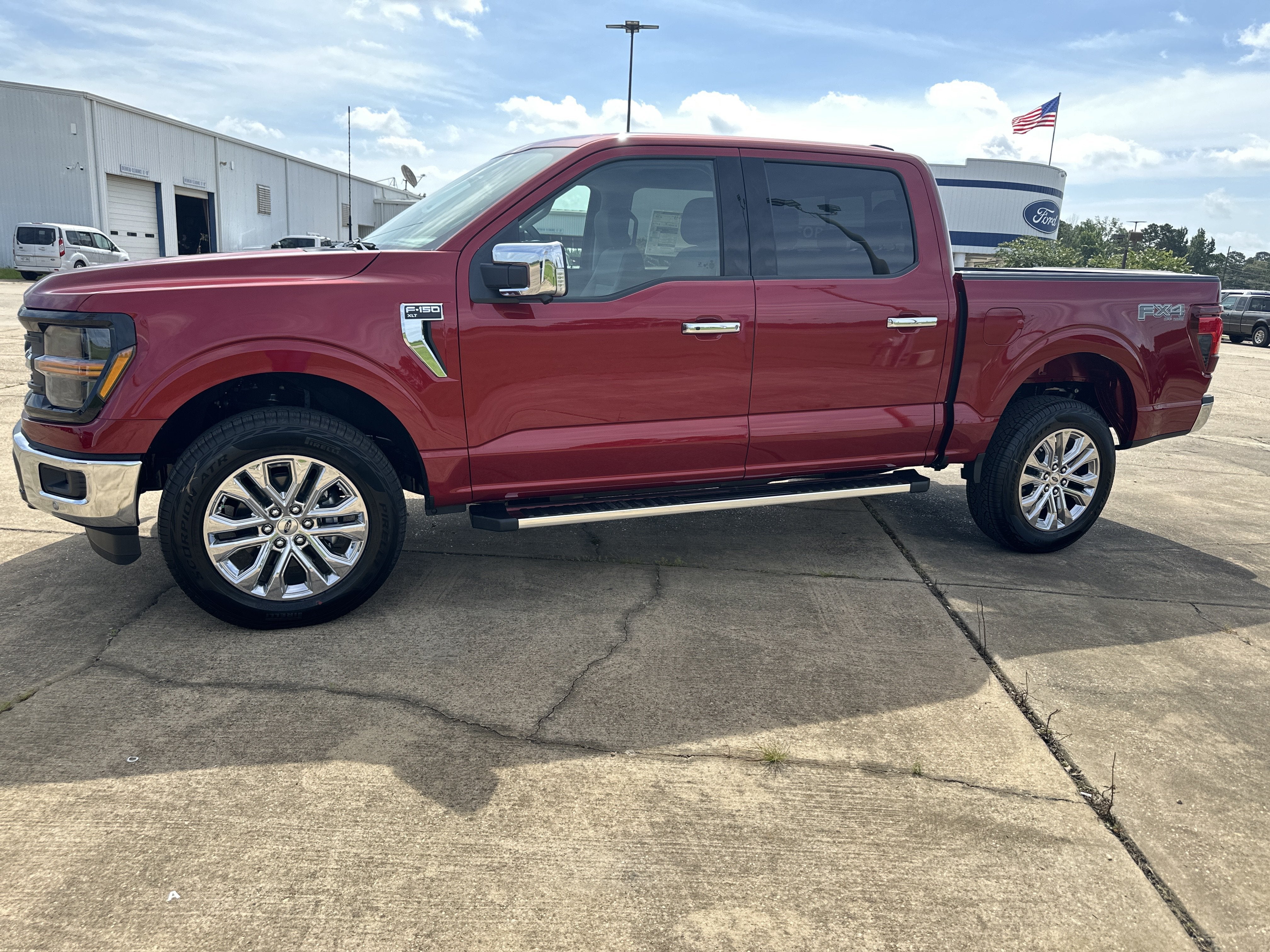 2026 Ford F-150 XLT in Ruby Red Metallic Tinted Clearcoat — front three-quarter view