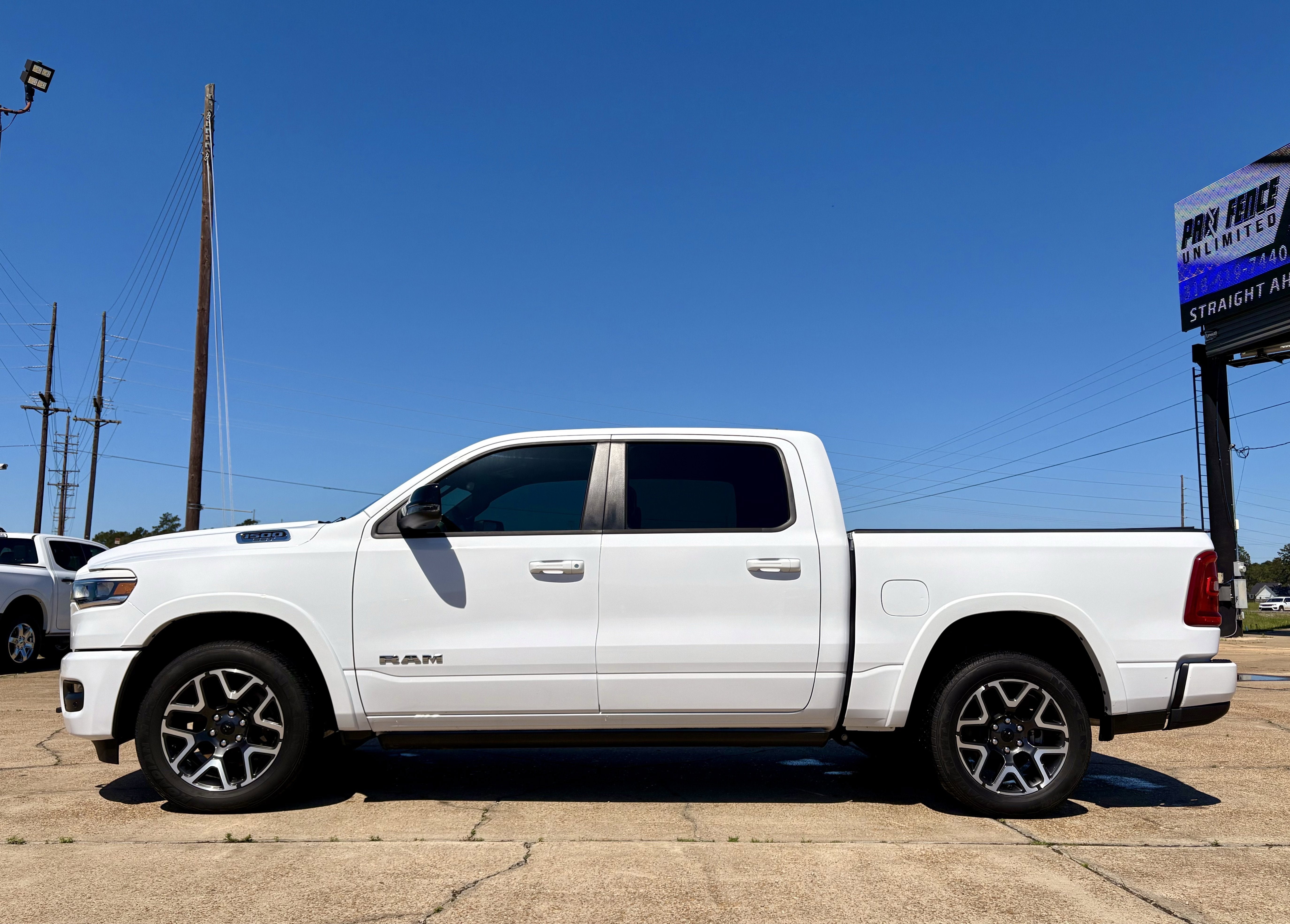 2025 RAM 1500 Laramie in Bright White Clearcoat — front three-quarter view
