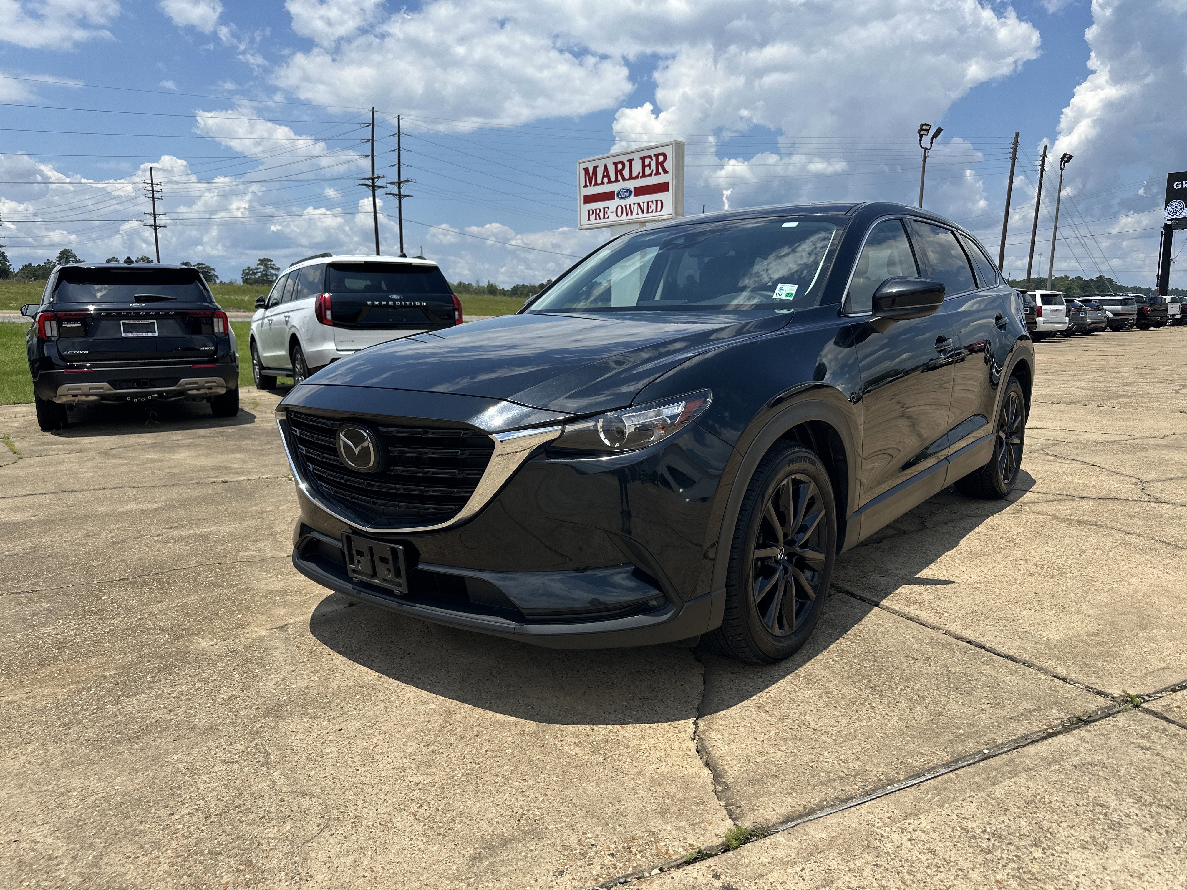 2023 Mazda Mazda CX-9 Touring Plus in Jet Black Mica — front three-quarter view
